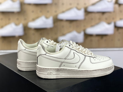 Cream low-top sneakers with rope laces and dark contrast stitching