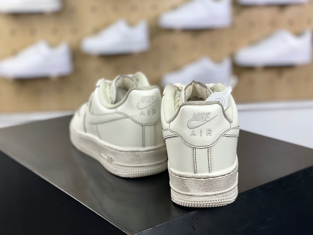 Cream low-top sneakers with rope laces and dark contrast stitching