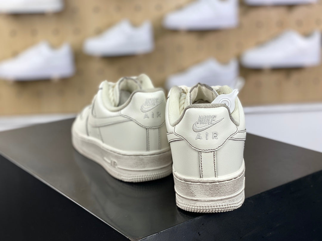 Cream low-top sneakers with rope laces and dark contrast stitching
