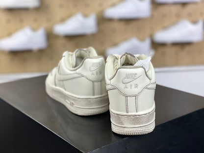 Cream low-top sneakers with rope laces and dark contrast stitching