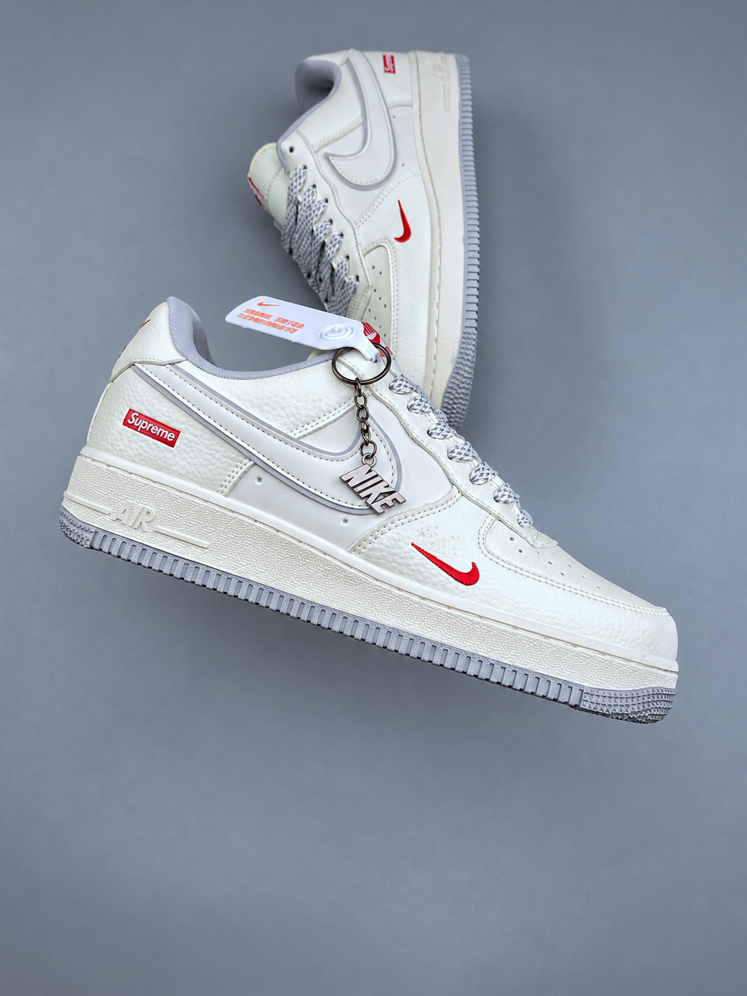 White low top sneakers, two shoes, hand removed